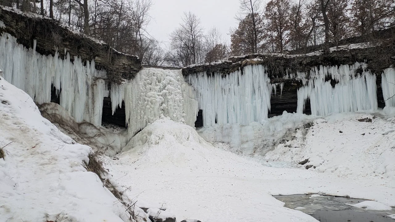 Frozen waterfall surrounded by snow in Minneapolis