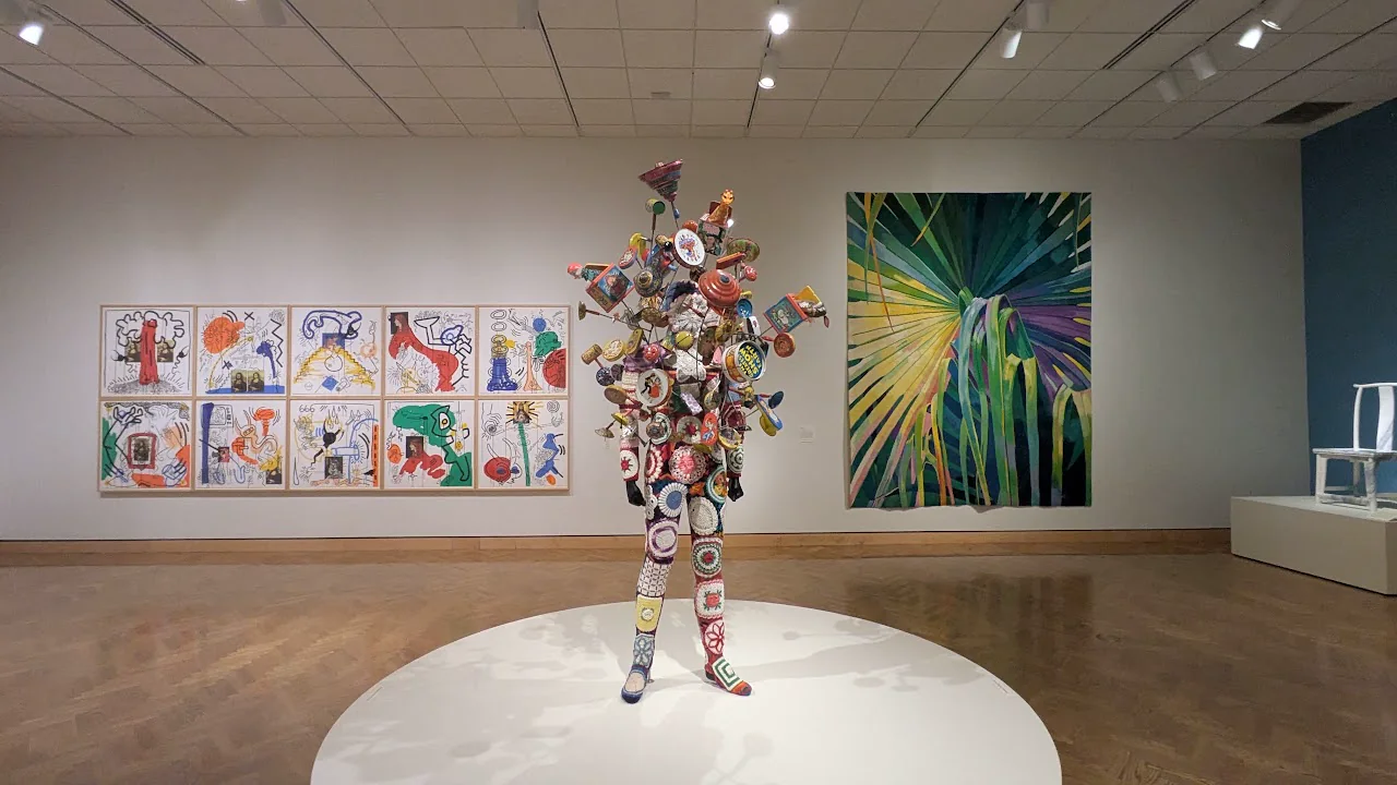 Colorful figure installation inside a Twin Cities art museum